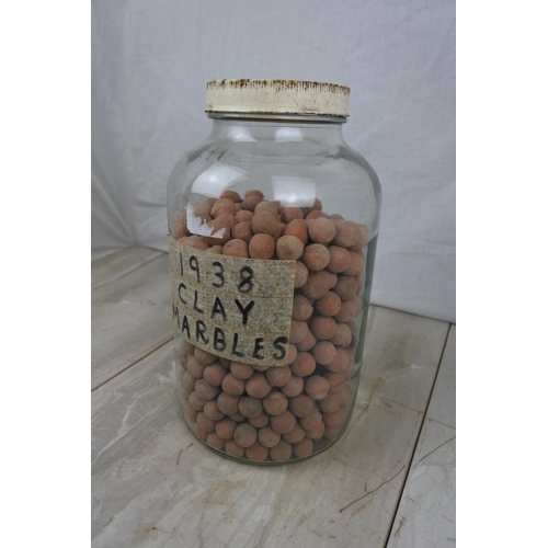 134 - A jar of clay marbles.