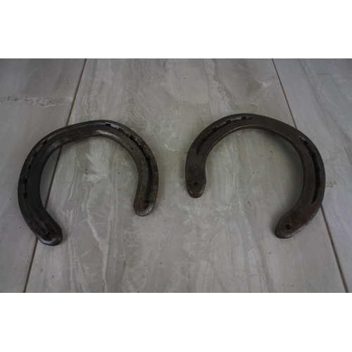 181 - Two antique horseshoes.