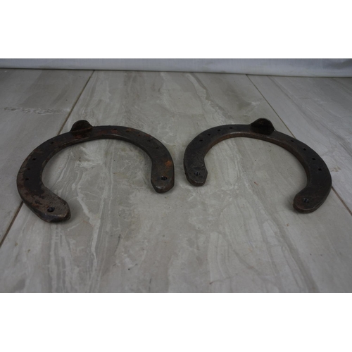 181 - Two antique horseshoes.