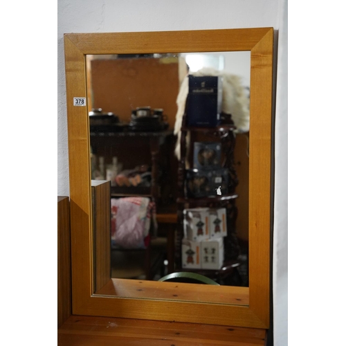 378 - A pine framed mirror, measuring 61cm x 86cm.