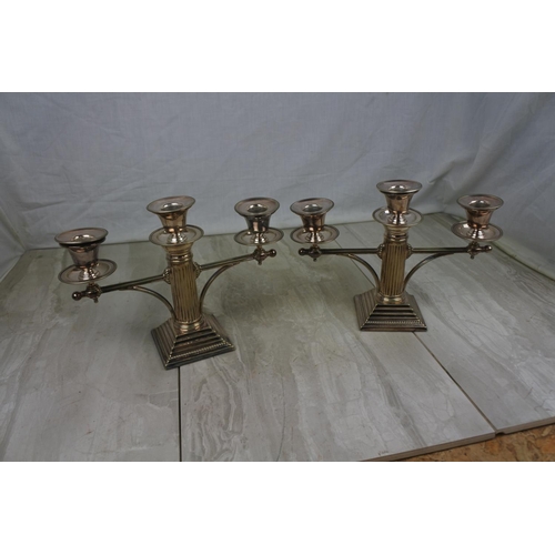 438 - A stunning pair of silver plated column candelabra's, measuring 19cm tall.