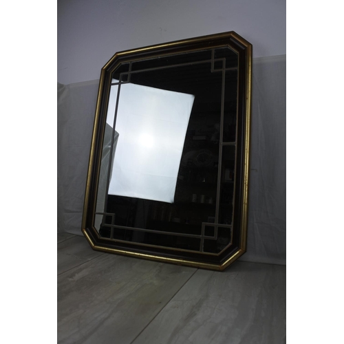 461 - A framed wall mirror with lead design, measuring 53cm x 68cm.