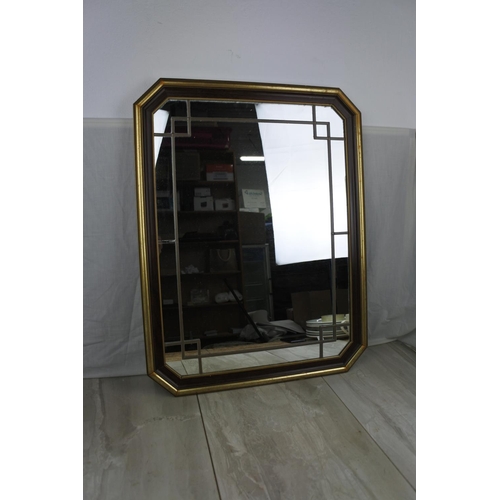 461 - A framed wall mirror with lead design, measuring 53cm x 68cm.