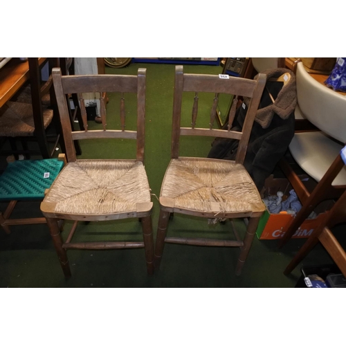 498 - A pair of Irish pine framed and rattan topped chairs.