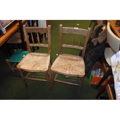 498 - A pair of Irish pine framed and rattan topped chairs.