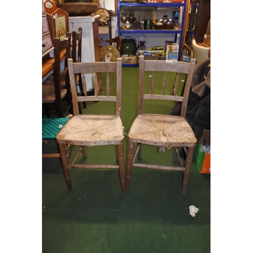 498 - A pair of Irish pine framed and rattan topped chairs.