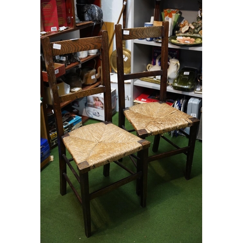 503 - A pair of oak framed rattan topped  chairs.