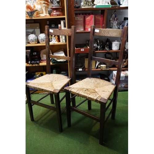 503 - A pair of oak framed rattan topped  chairs.