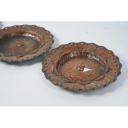 512 - A set of three antique copper beaten and engraved plates, 19cm diameter.