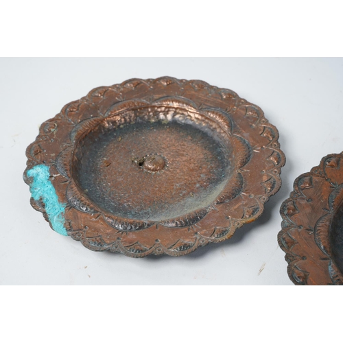 512 - A set of three antique copper beaten and engraved plates, 19cm diameter.