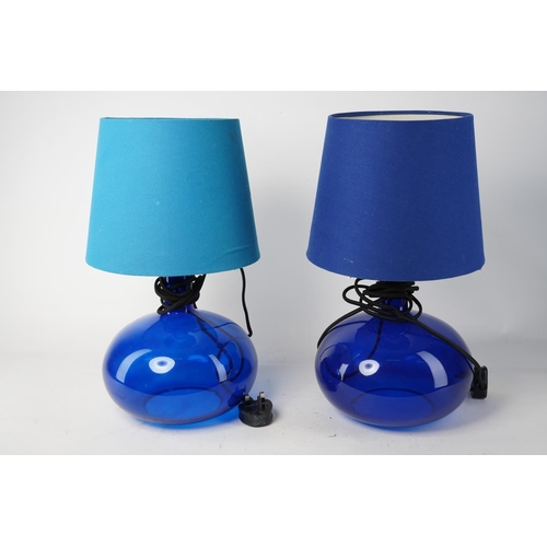 513 - A stunning pair of blue glass table lamps and shades, 43cm tall.