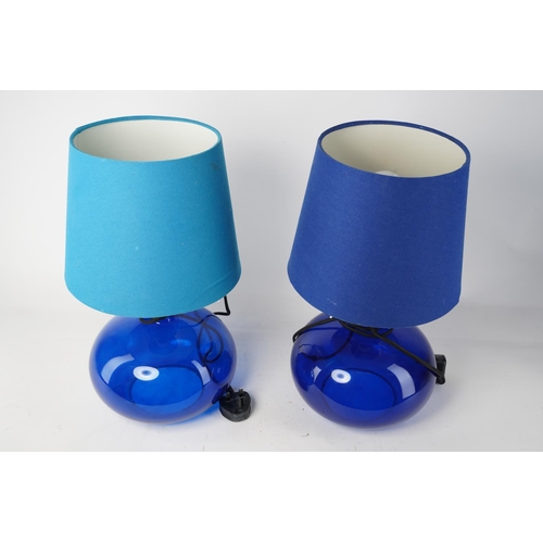 513 - A stunning pair of blue glass table lamps and shades, 43cm tall.