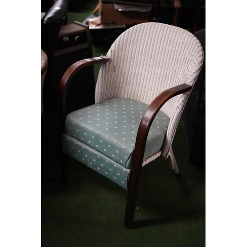 522 - A vintage rattan and upholstered chair.