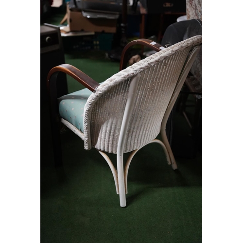 522 - A vintage rattan and upholstered chair.