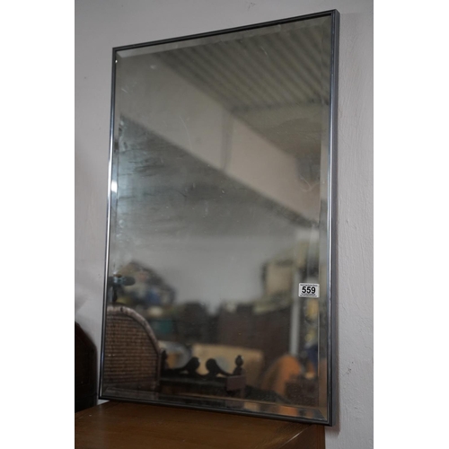 559 - A bevelled framed mirror.