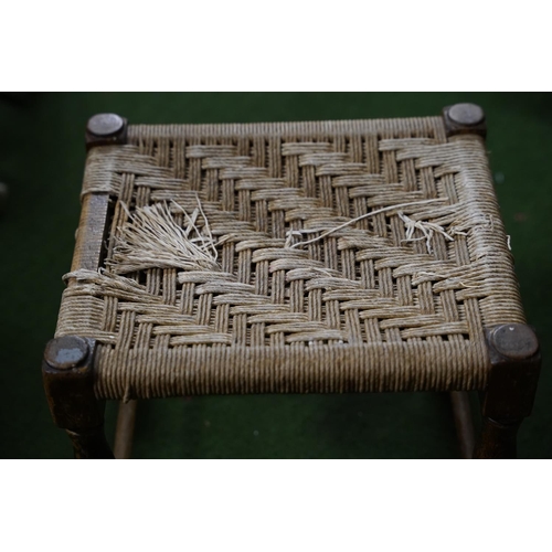 568 - An antique framed stool with weaved top.