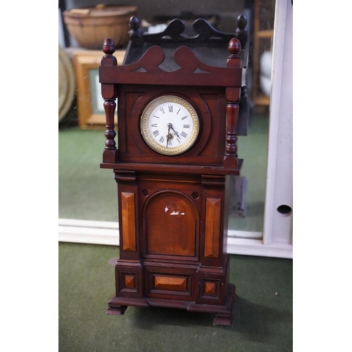 571 - A mahogany cased wall clock.