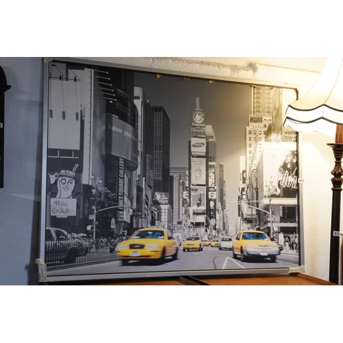 817 - A large framed picture of New York City.