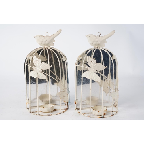 1026 - A pair of metal cage candleholders decorated with butterflies.