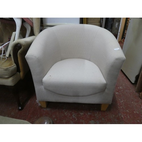 1123 - An upholstered modern tub chair.