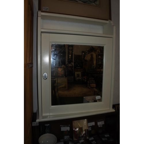 1133 - A wall cabinet with mirror.