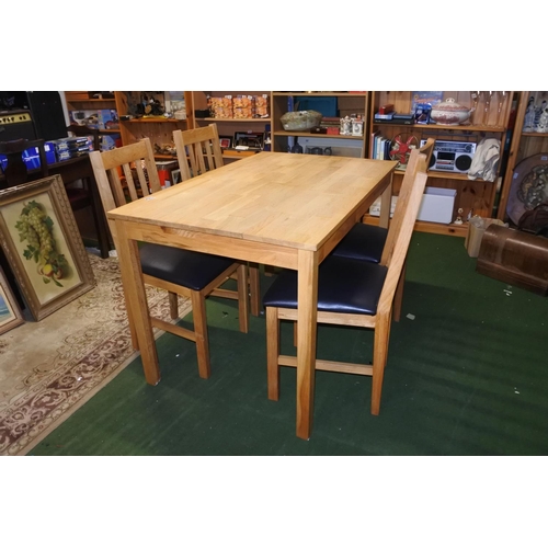 1162 - A pine dining room table and four chairs.