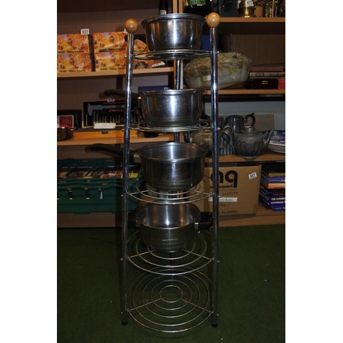 1163 - A five tier saucepan stand and some saucepans.