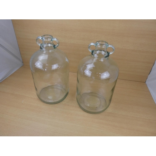 508 - Two clear glass demijohn bottles.