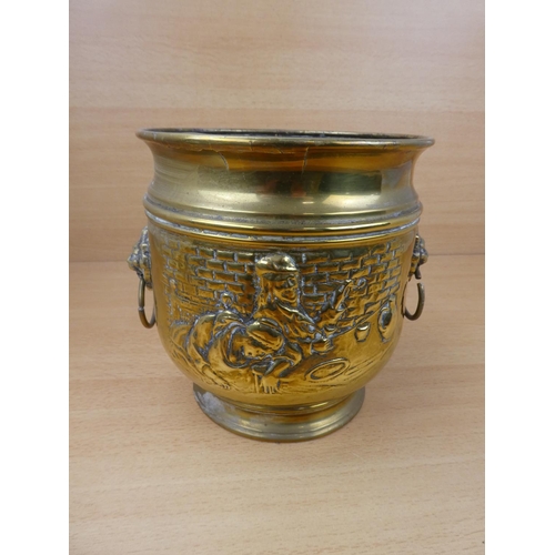 513 - A vintage brass plant pot with lion mask handles.