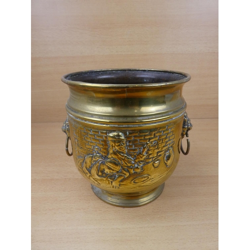 513 - A vintage brass plant pot with lion mask handles.