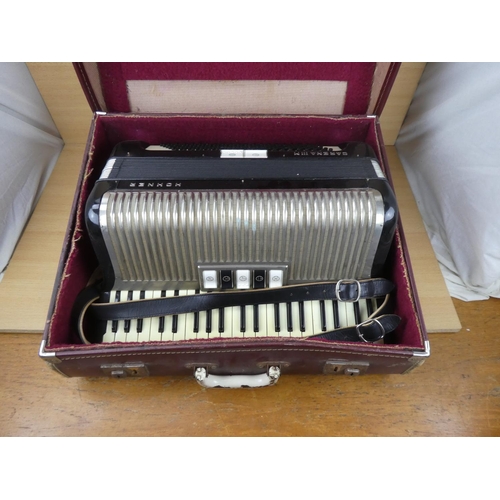 516 - A vintage cased Honner accordion.