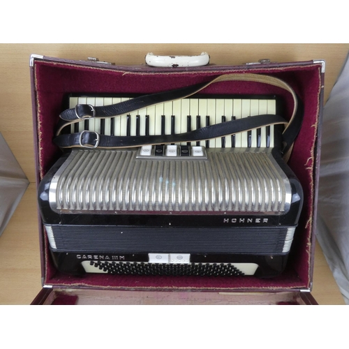 516 - A vintage cased Honner accordion.