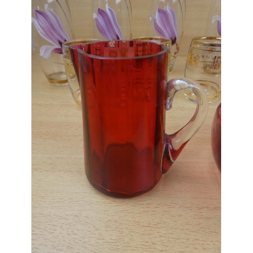 522 - An antique ruby glass bowl and jug and two sets of vintage glasses.