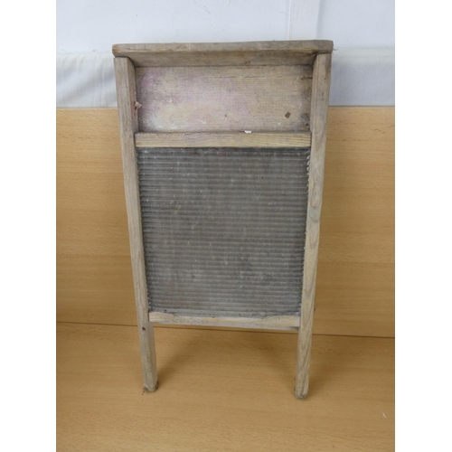 528 - A vintage glass washboard.