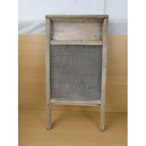 528 - A vintage glass washboard.