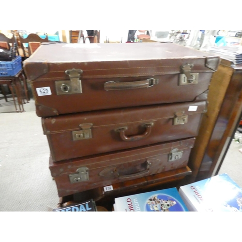 529 - Three vintage leather suitcases.