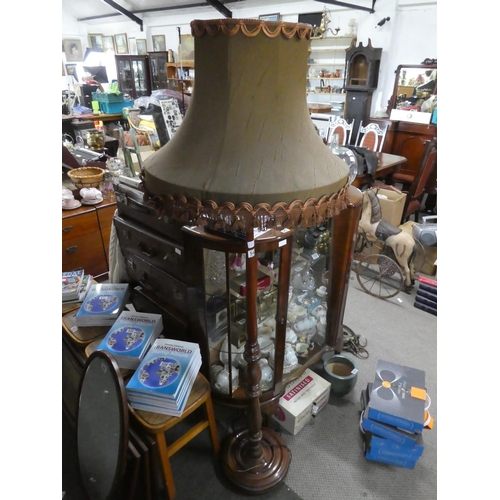 542 - A mahogany standard lamp and shade.