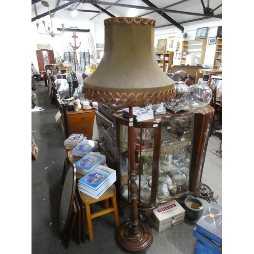 542 - A mahogany standard lamp and shade.