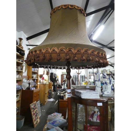 542 - A mahogany standard lamp and shade.