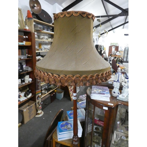 542 - A mahogany standard lamp and shade.