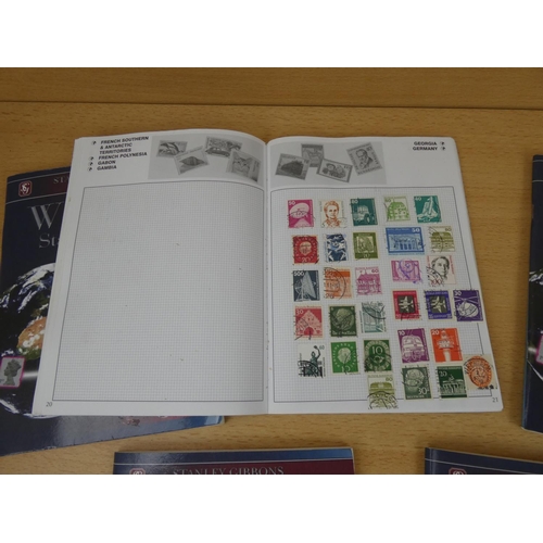 543 - A set of five Stanley Gibbons 'World' stamp albums and contents.