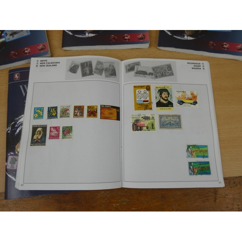 543 - A set of five Stanley Gibbons 'World' stamp albums and contents.