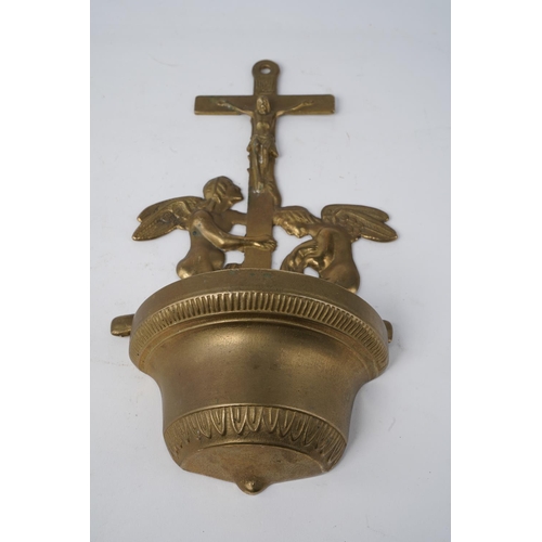 642 - A Religious brass wall mounted font.