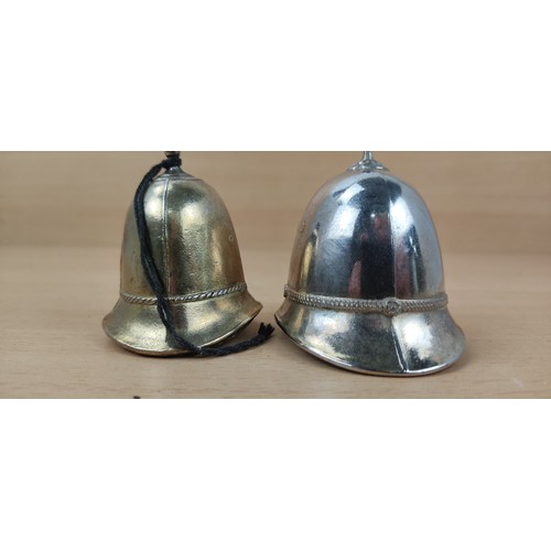 42 - 2 novelty bells in the style of a policeman's helmets.