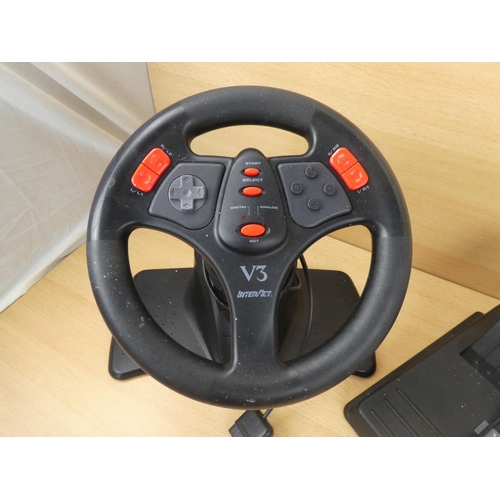 18 - A Playstation V3 Interact steering wheel and pedal set.