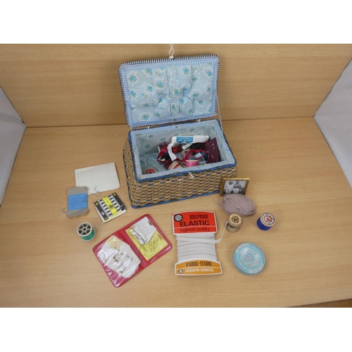 28 - A vintage sewing basket and contents.