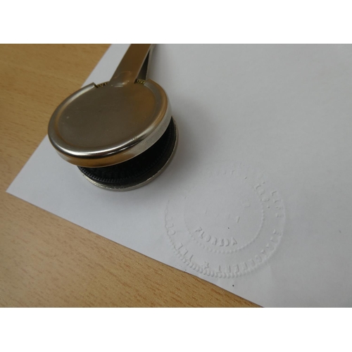 45 - An embossed stamper.