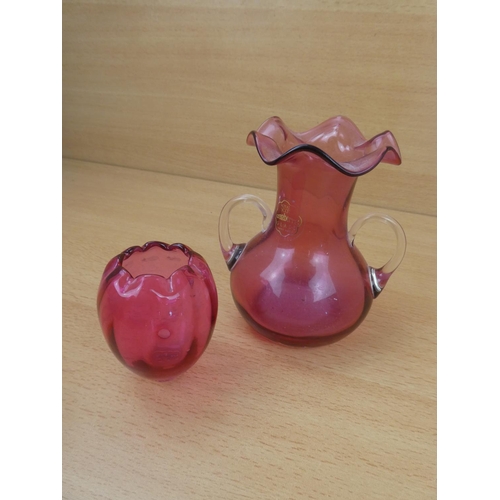 67 - A small antique ruby glass pot and a Royal Scott cranberry glass two handled vase.