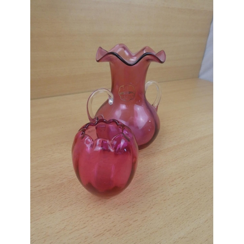 67 - A small antique ruby glass pot and a Royal Scott cranberry glass two handled vase.