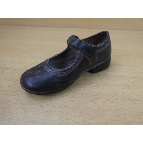 85 - An antique cast metal child's shoe.